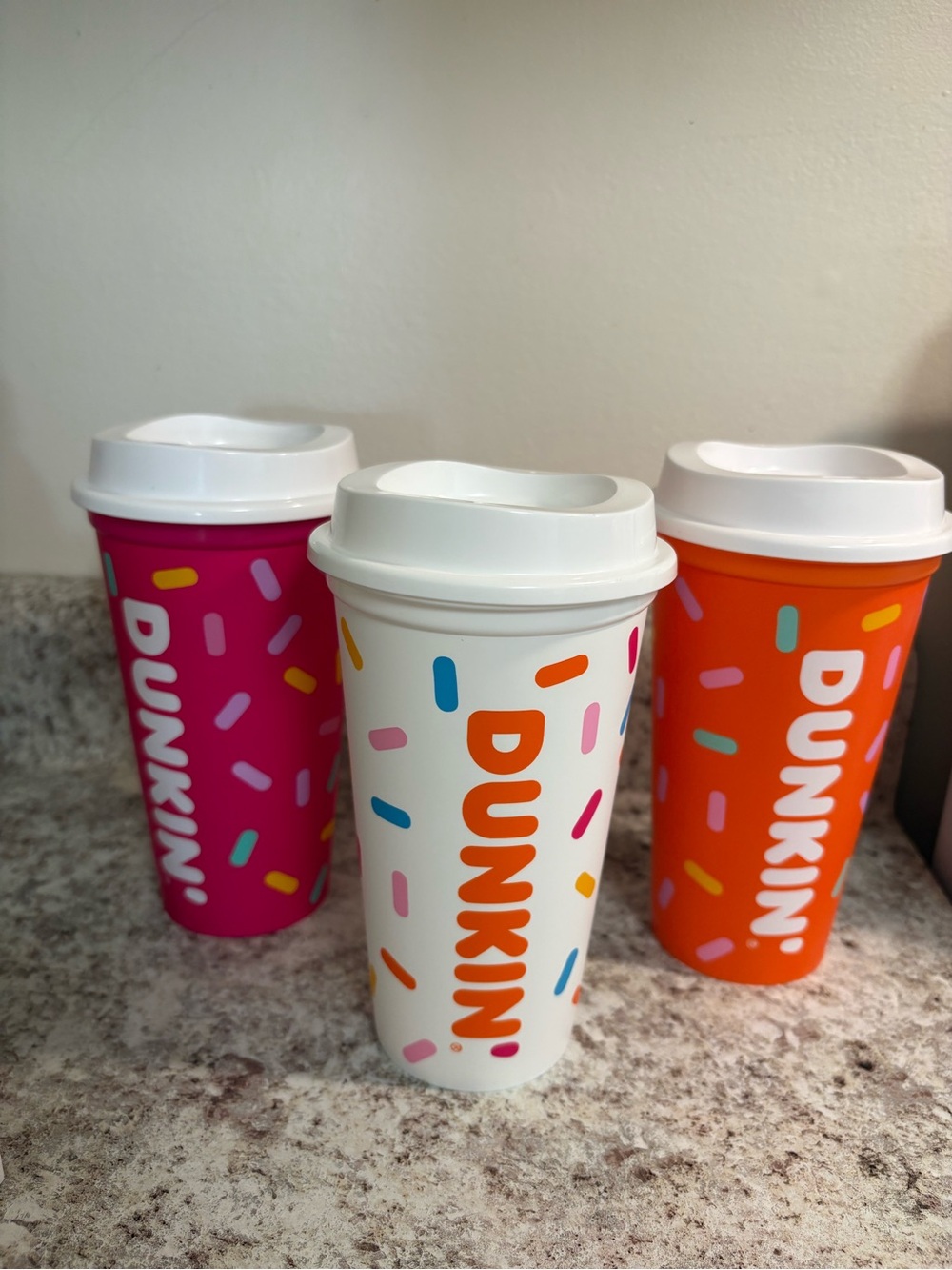 DUNKIN® Reusable Travel Cups - White, Pink, and Orange with Colorful Sprinkles